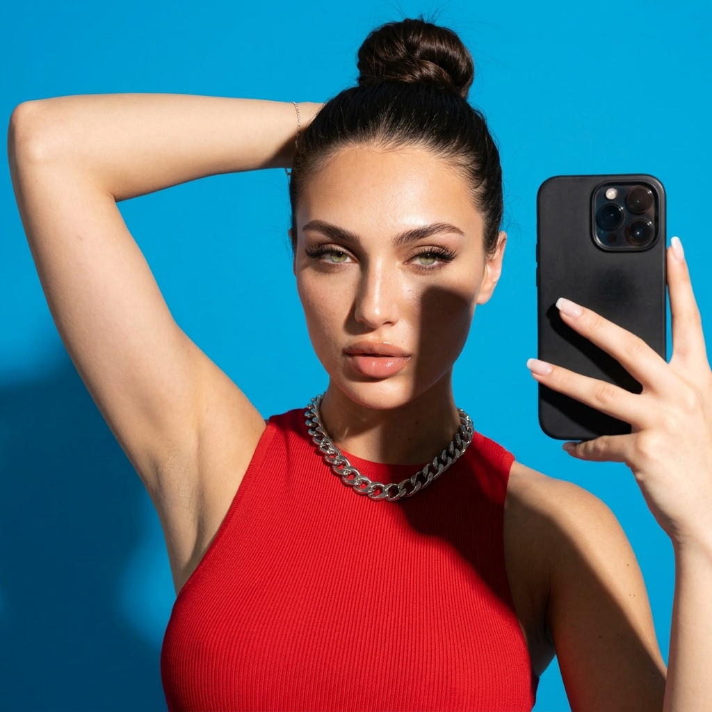 woman in a tight close-up selfie portrait in a saturated seamless studio backdrop.