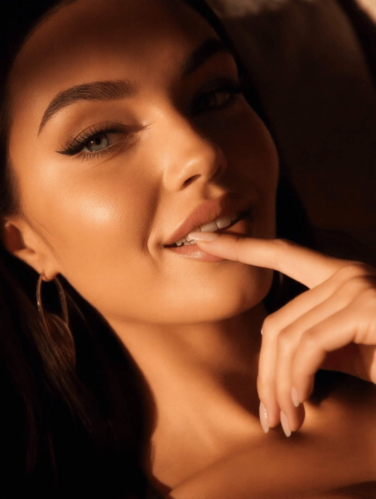 Amber Lit Portrait Playful Smile Gold Hoops