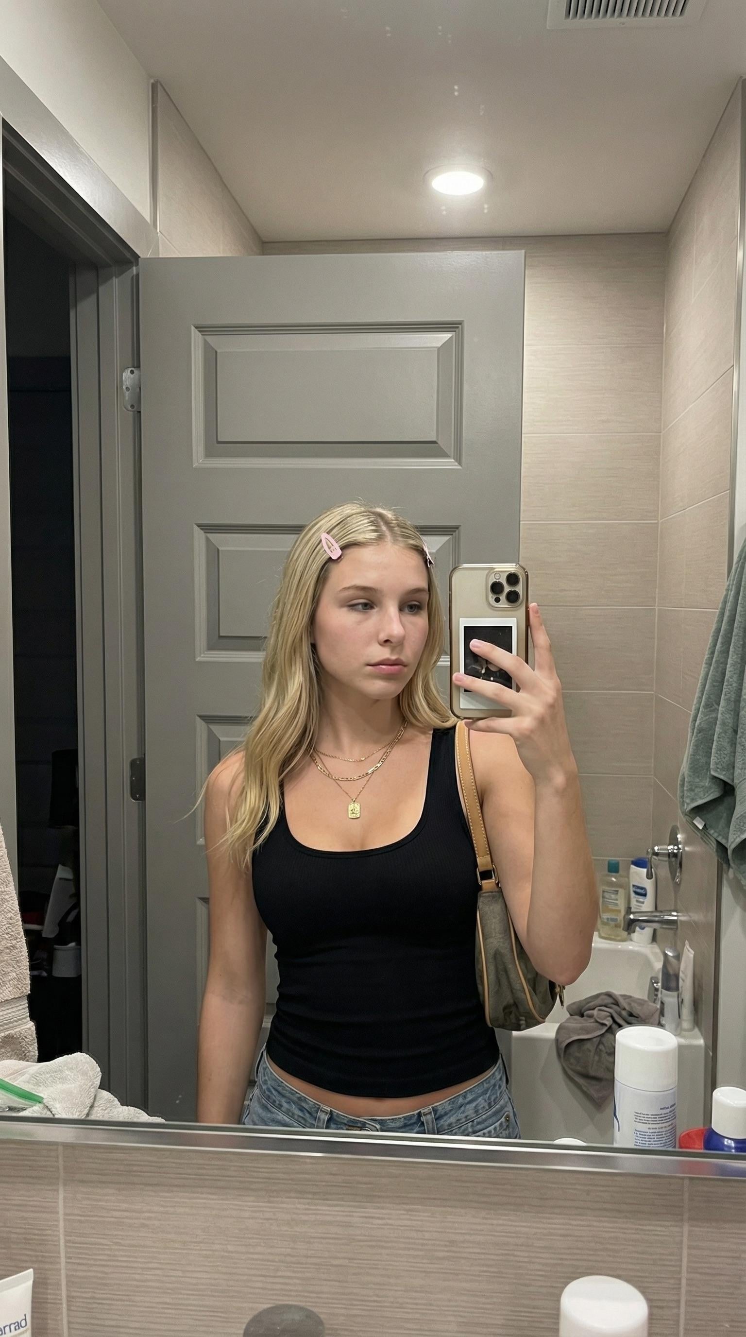 Black Tank Top And Light Wash Denim In Bathroom