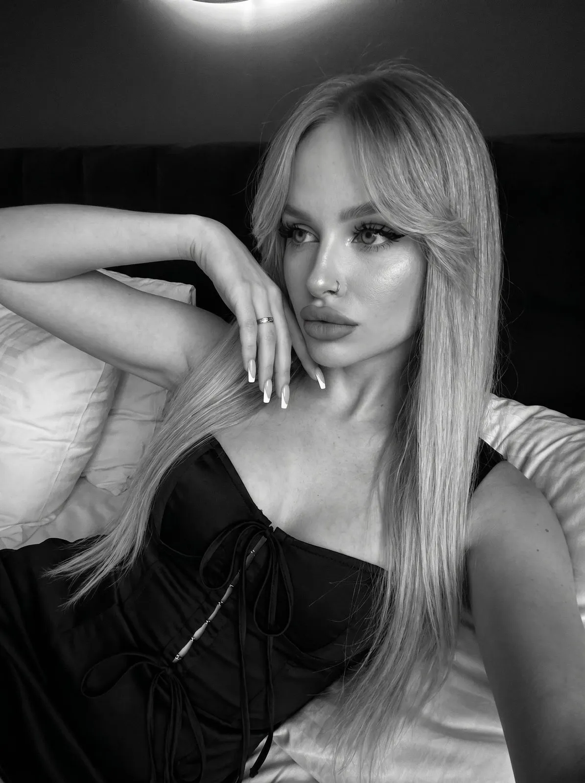 Piercings And Makeup And Manicure In Bedroom Portrait