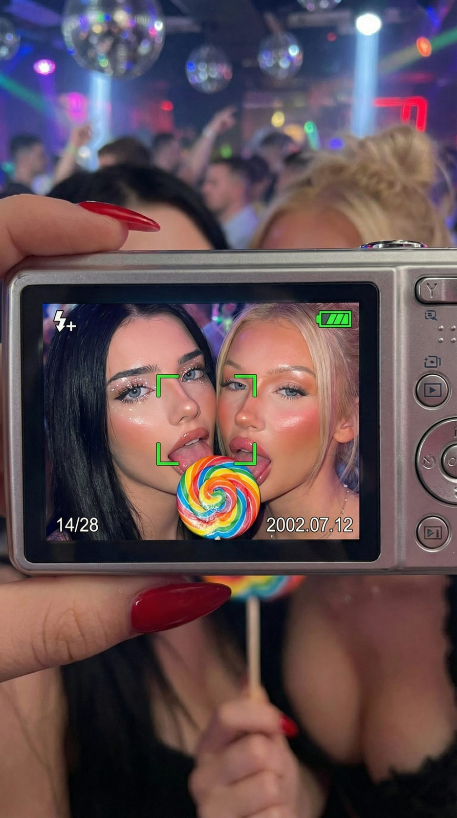 A close-up shot of a digital camera screen showing two individuals with rainbow lollipops.