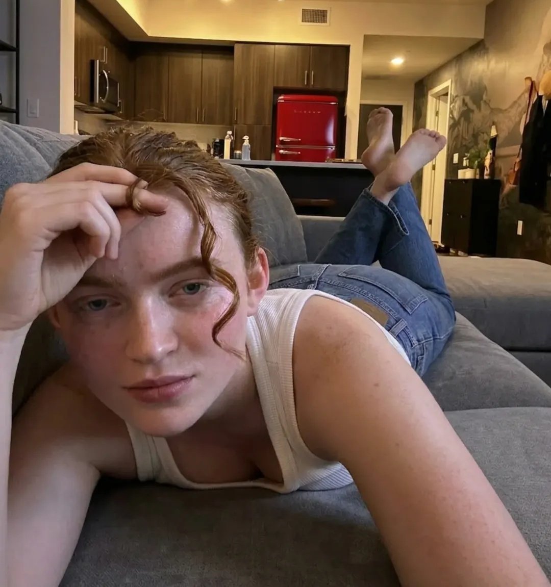Sadie Sink Red Hair On Plush Sofa Apartment