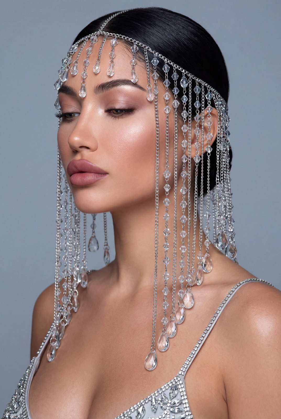 Ultra-detailed beauty portrait featuring a model with a crystal veil headpiece in a minimalist studio.