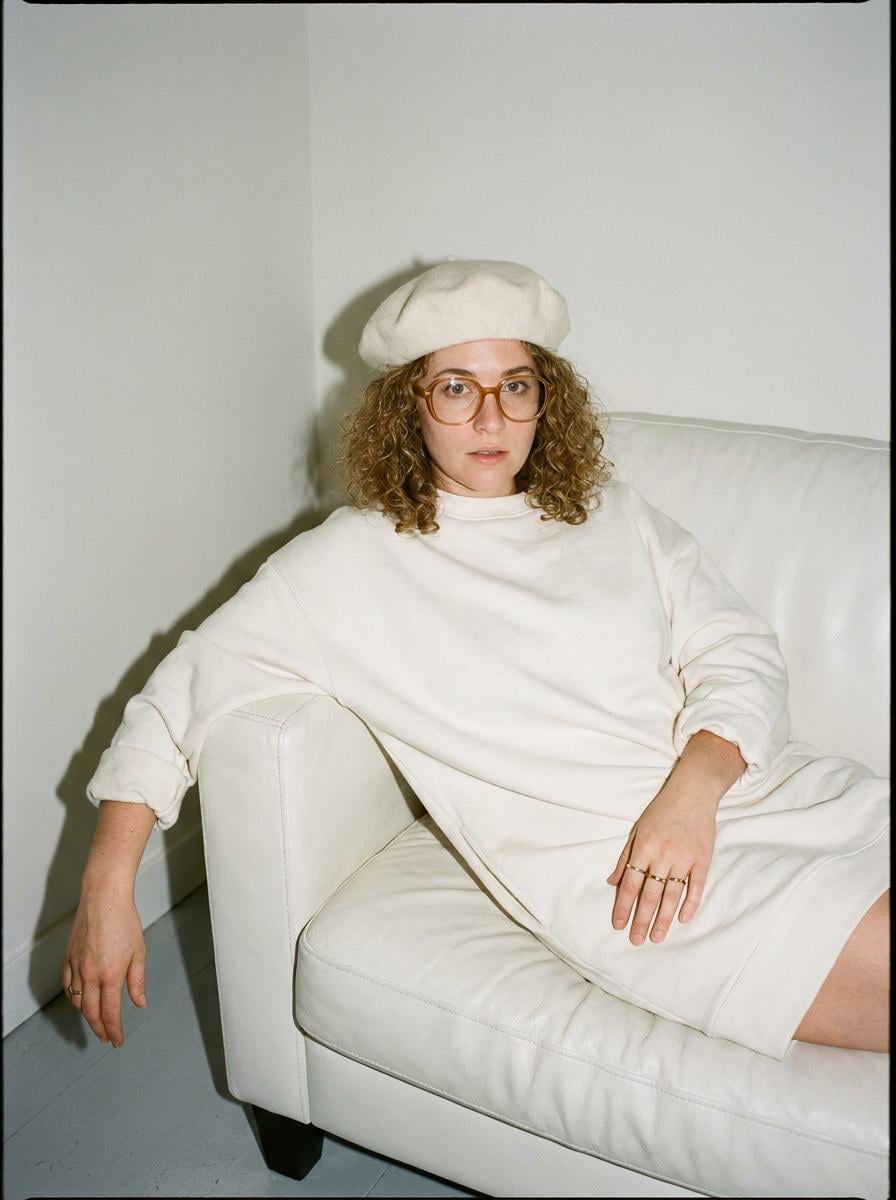 Casual Fashion Portrait Seated On White Couch
