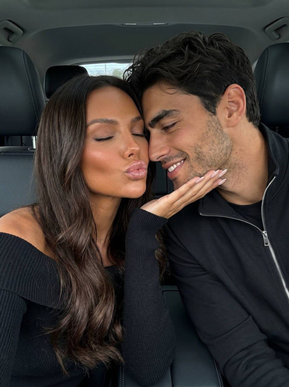 A luxurious couple selfie inside a premium vehicle, showcasing their natural beauty and style.