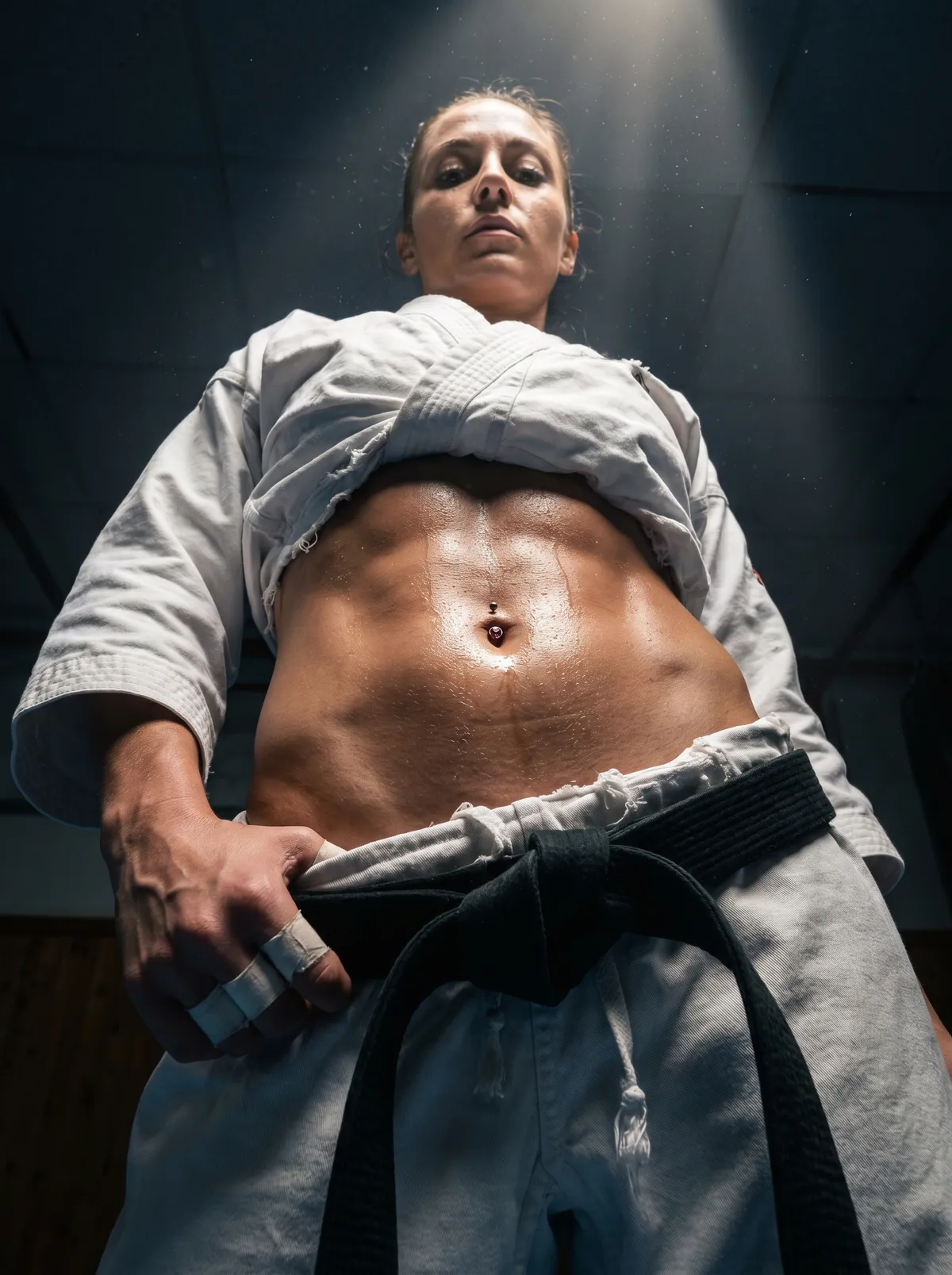 Martial Artist Low Angle Sweat Gi Dojo Light Shafts