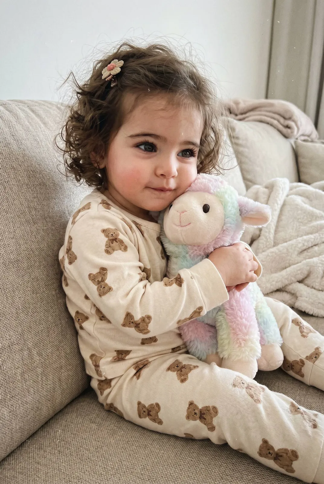 Toddler Girl Hugging Plush Lamb Cozy Pajamas Couch