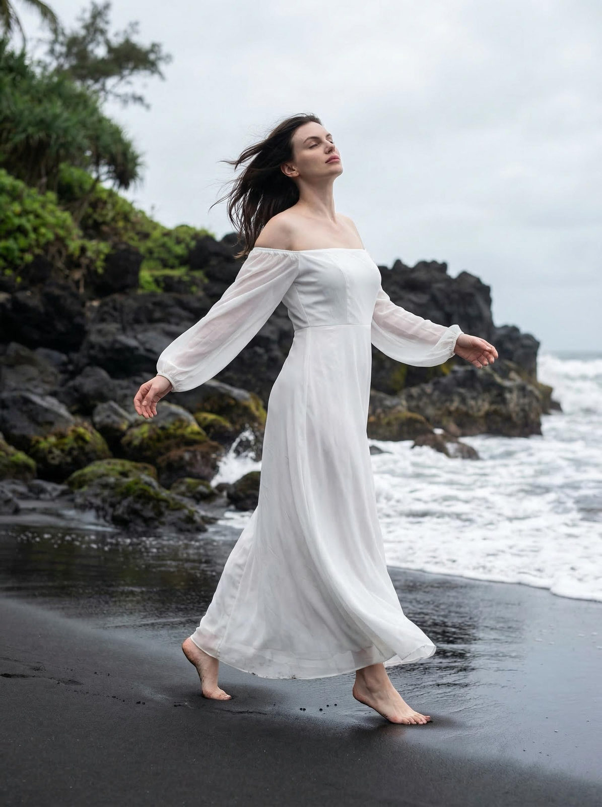 A woman in a flowing white dress on a black sand beach, waves crashing around her, hair fluttering in the wind.