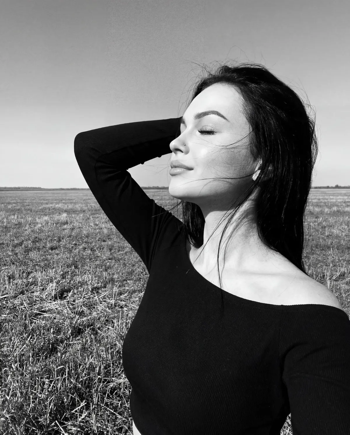 Girl In Open Field Enjoying Sun And Wind