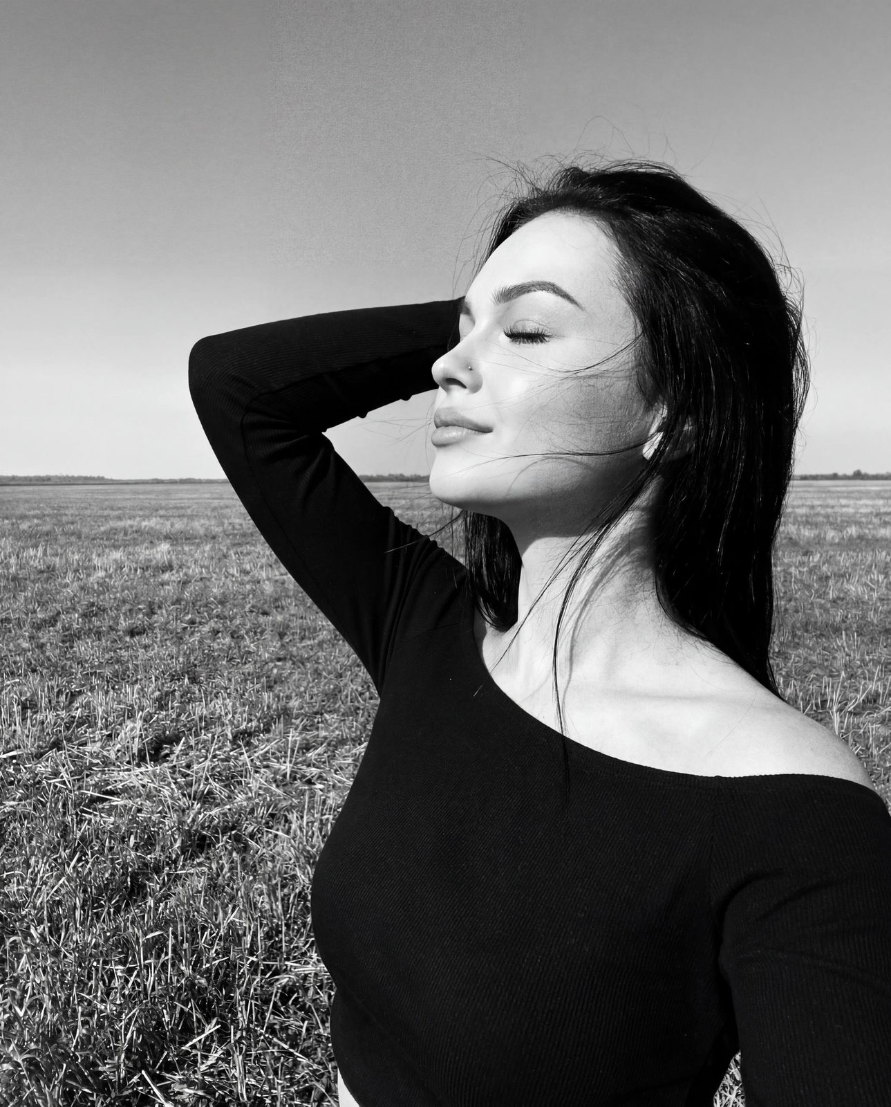 Girl In Open Field Enjoying Sun And Wind