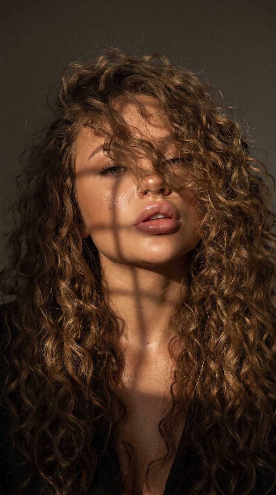 Mysterious Face With Curly Hair And Lattice Light