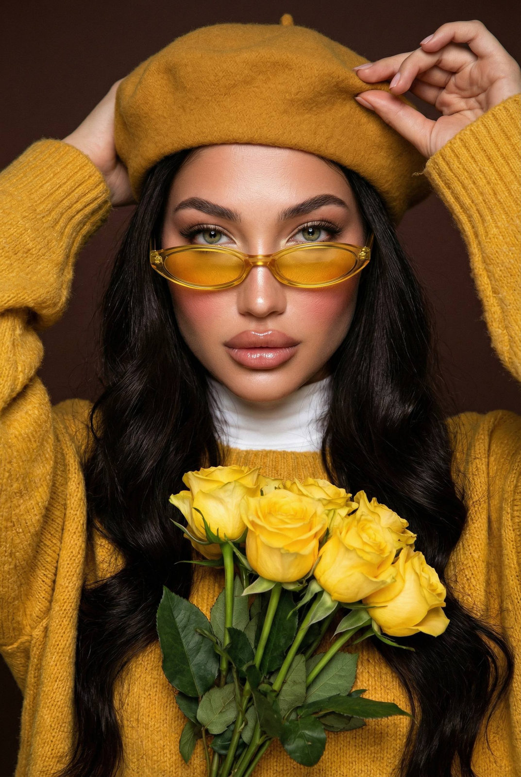 Close-up portrait of a woman in a yellow beret holding roses against a warm brown background.
