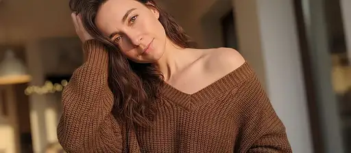 Woman With Wavy Dark Brown Hair Wearing Off-shoulder Oversized Brown