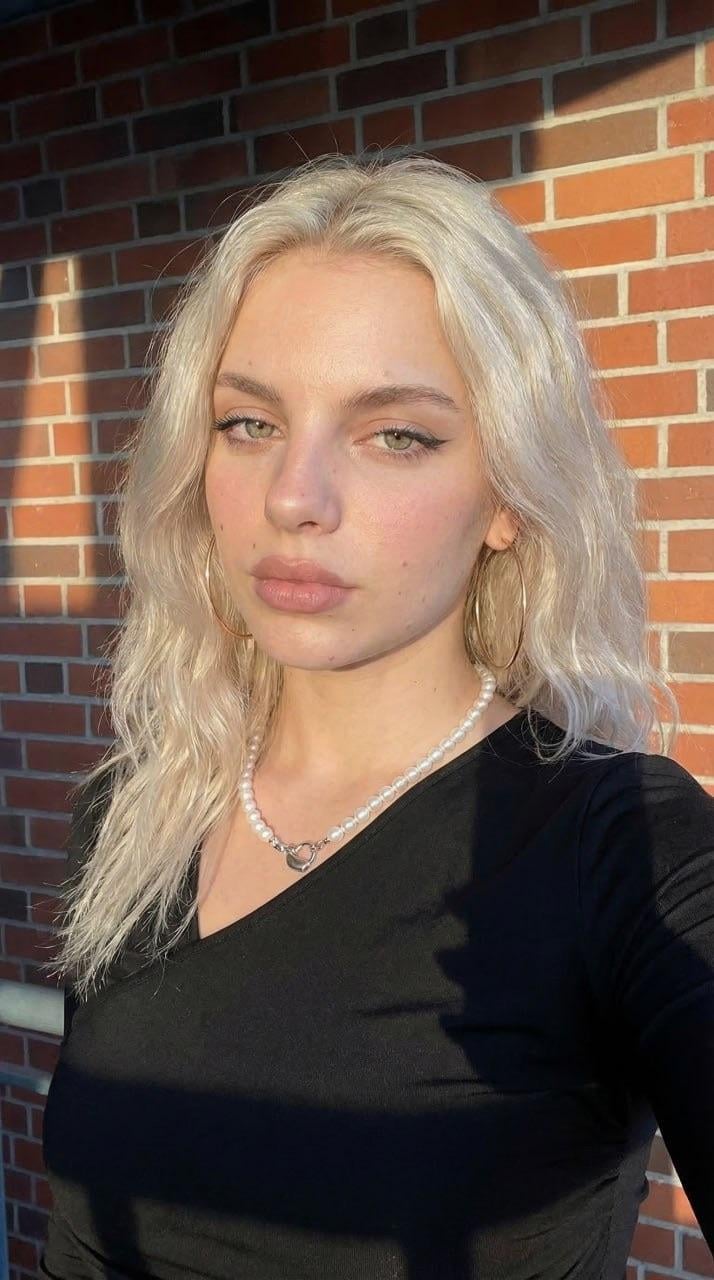 Golden Hour Portrait Rustic Brick Wall Black V Neck Pearls