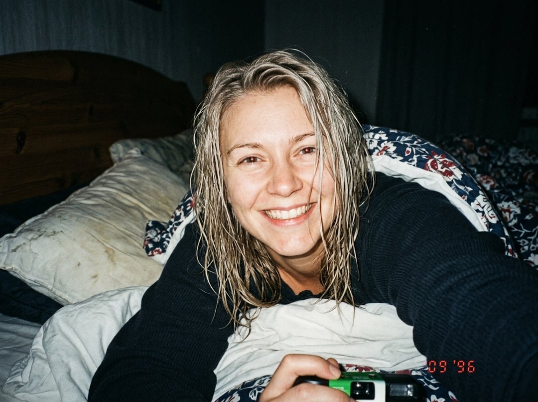 1990s Film Person Holding Camera In Bedroom