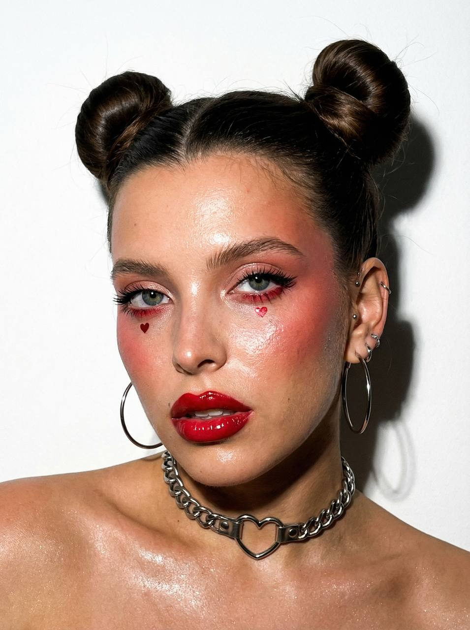 Ultra-realistic portrait with bright red heart makeup and silver accessories, shot on iPhone with flash.