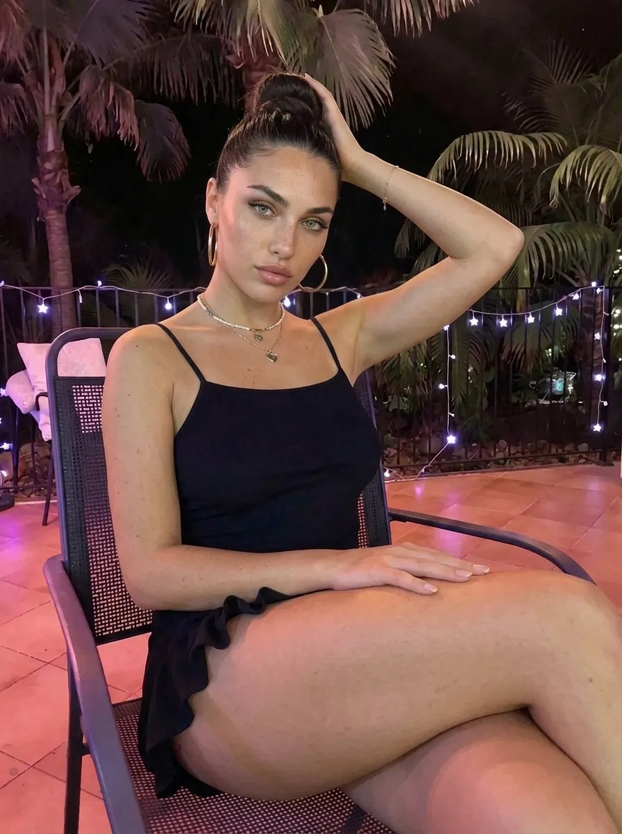 Black Mini Dress On Tropical Patio At Night