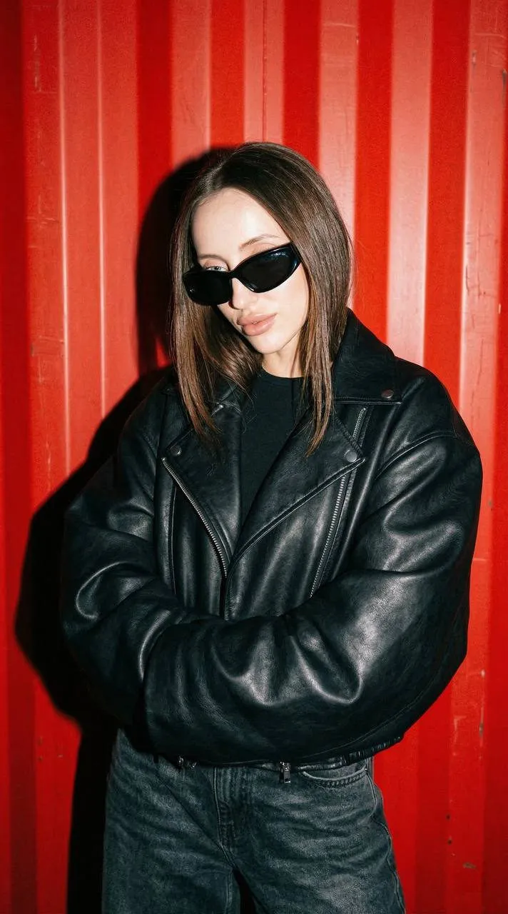 Sunglasses In Y2k Street Style By A Red Wall