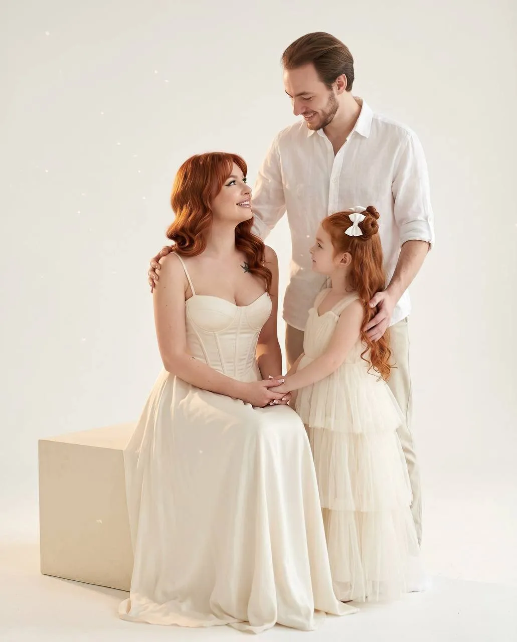 Family Moment In White Studio Ivory Gown