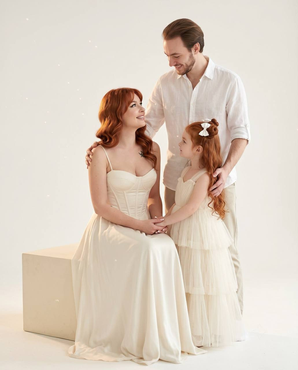 Family Moment In White Studio Ivory Gown