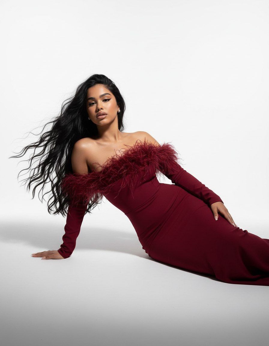A woman resembling a statue in a wine-colored dress under dramatic spotlights, her pose exuding grace and elegance.