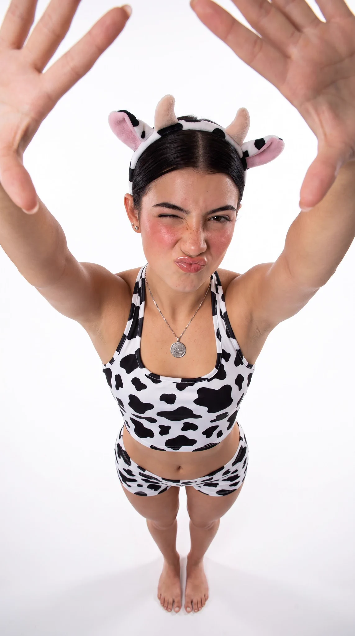 Adult Woman Cow Print Outfit Horn Headband Overhead Shot – Using the uploaded adult subject as the identity, recreate th