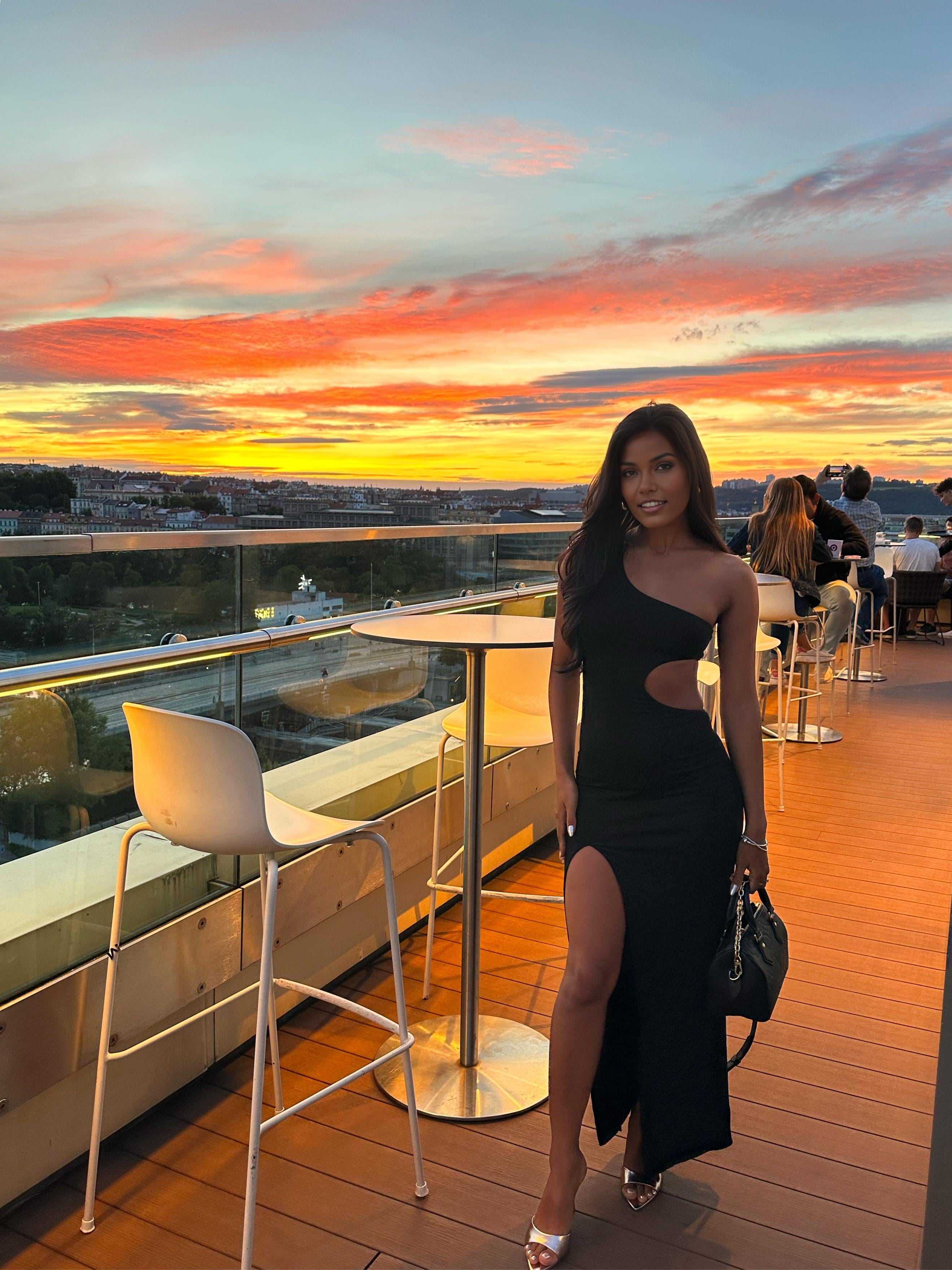 Form Fitting Black One Shoulder Maxi Dress On Modern Rooftop
