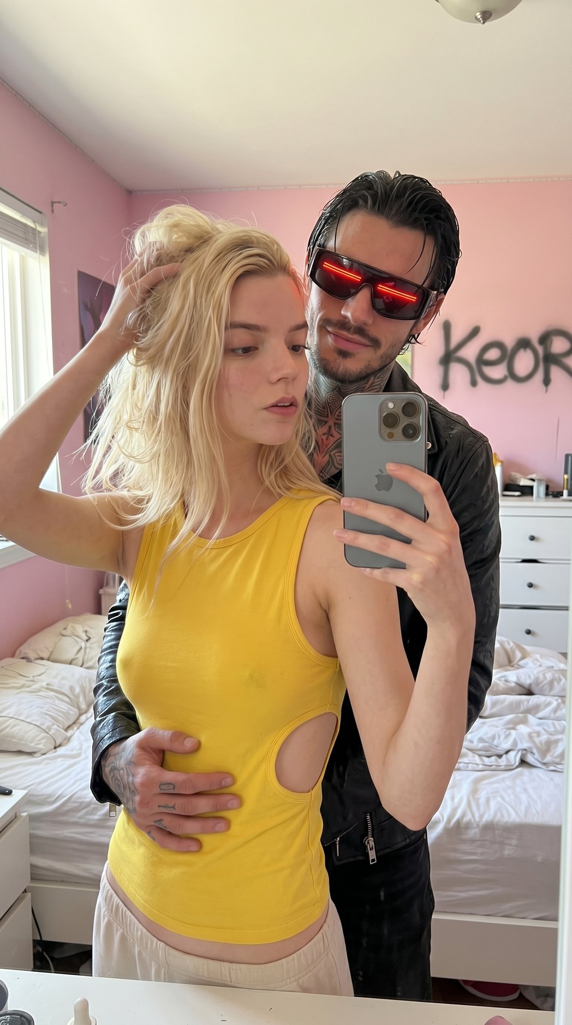 Close-up selfie taken in a bedroom of a person in a yellow tank top and leather jacket, featuring a bright and casual atmosphere.