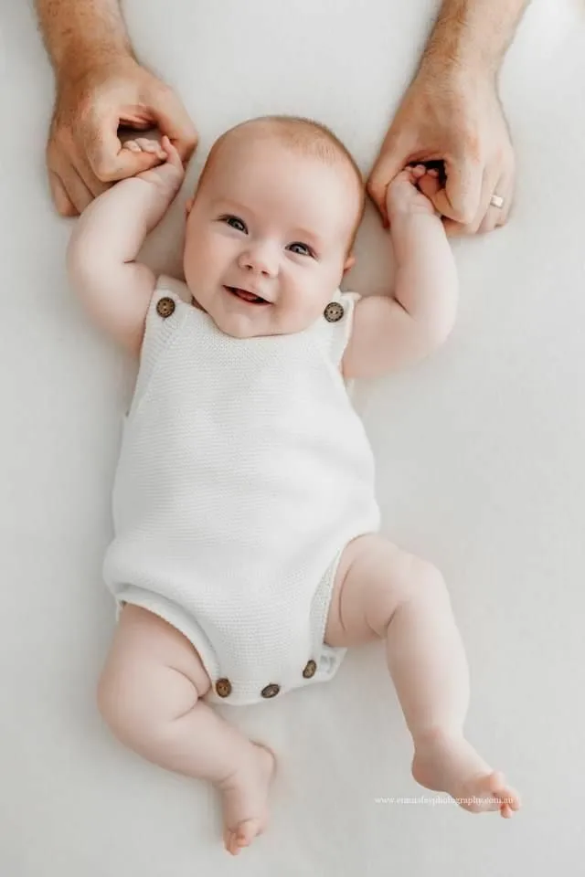 Joyful Baby With Adult Hands