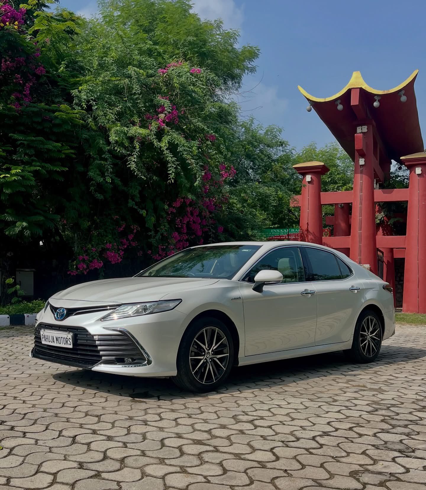 White Toyota Camry Hybrid Parked By Pagoda Gate