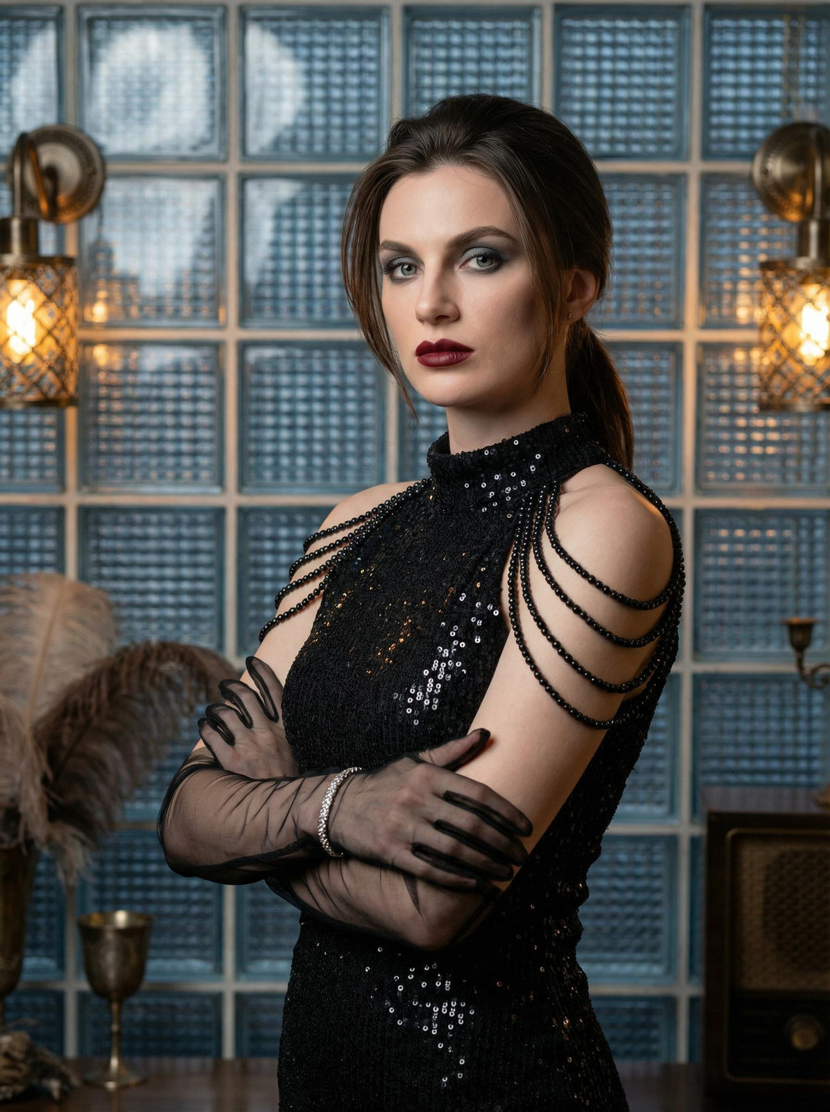 A half-length portrait of a woman in a sequined dress, arms crossed in a vintage-inspired interior, with soft lighting highlighting her features.
