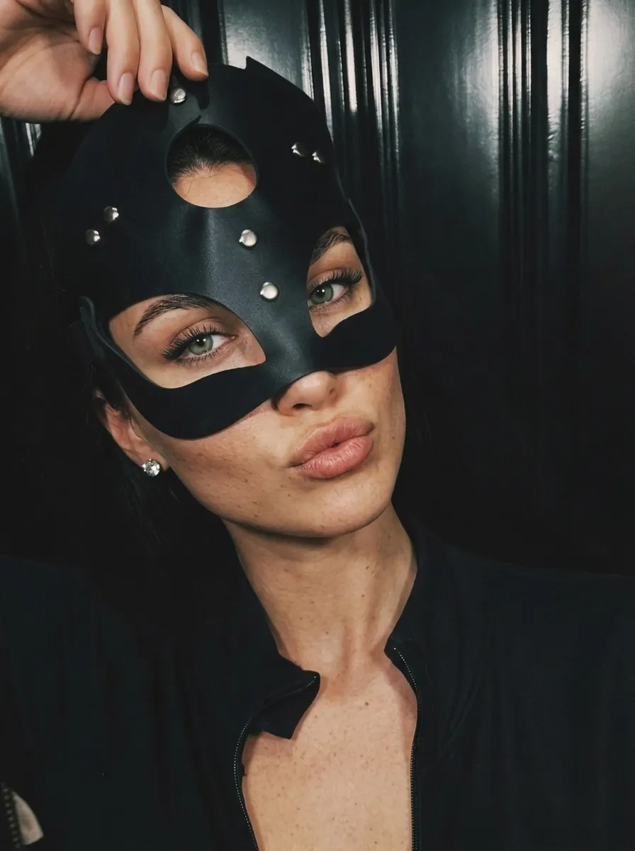 Touching Black Leather Mask Dark Background