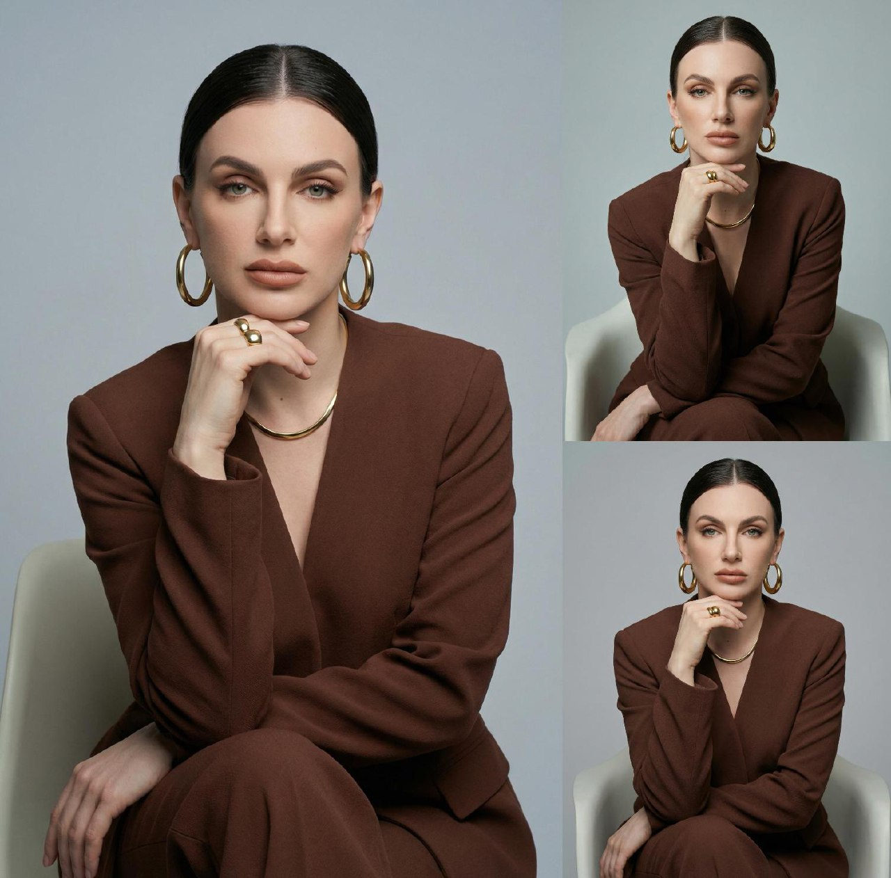 Studio portrait of a woman in a brown V-neck suit with gold jewelry against a light gray matte background.