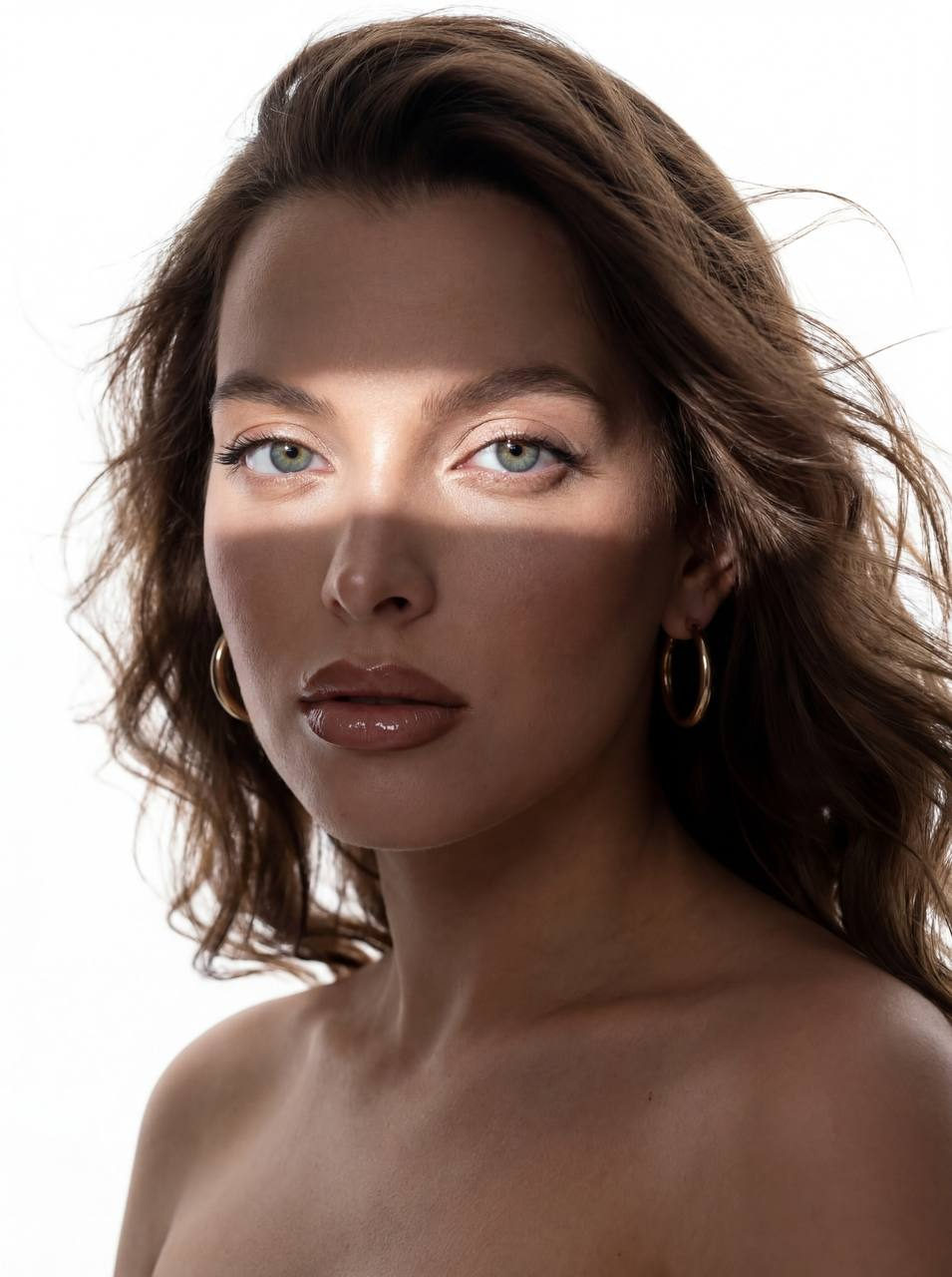 Ultra-realistic beauty portrait of woman with windblown hair, highlighting dynamic strands and lifelike skin texture.