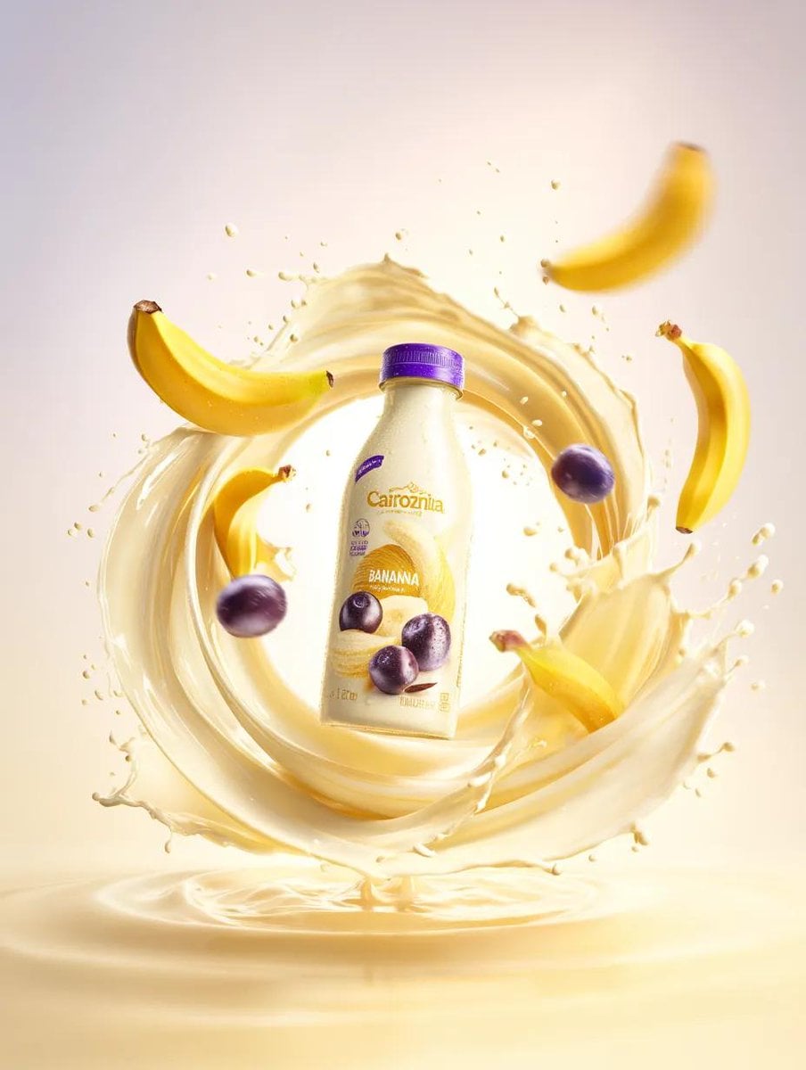 A premium banana milk drink splashing against a bright yellow background, with floating bananas and berries enhancing the dynamic scene.