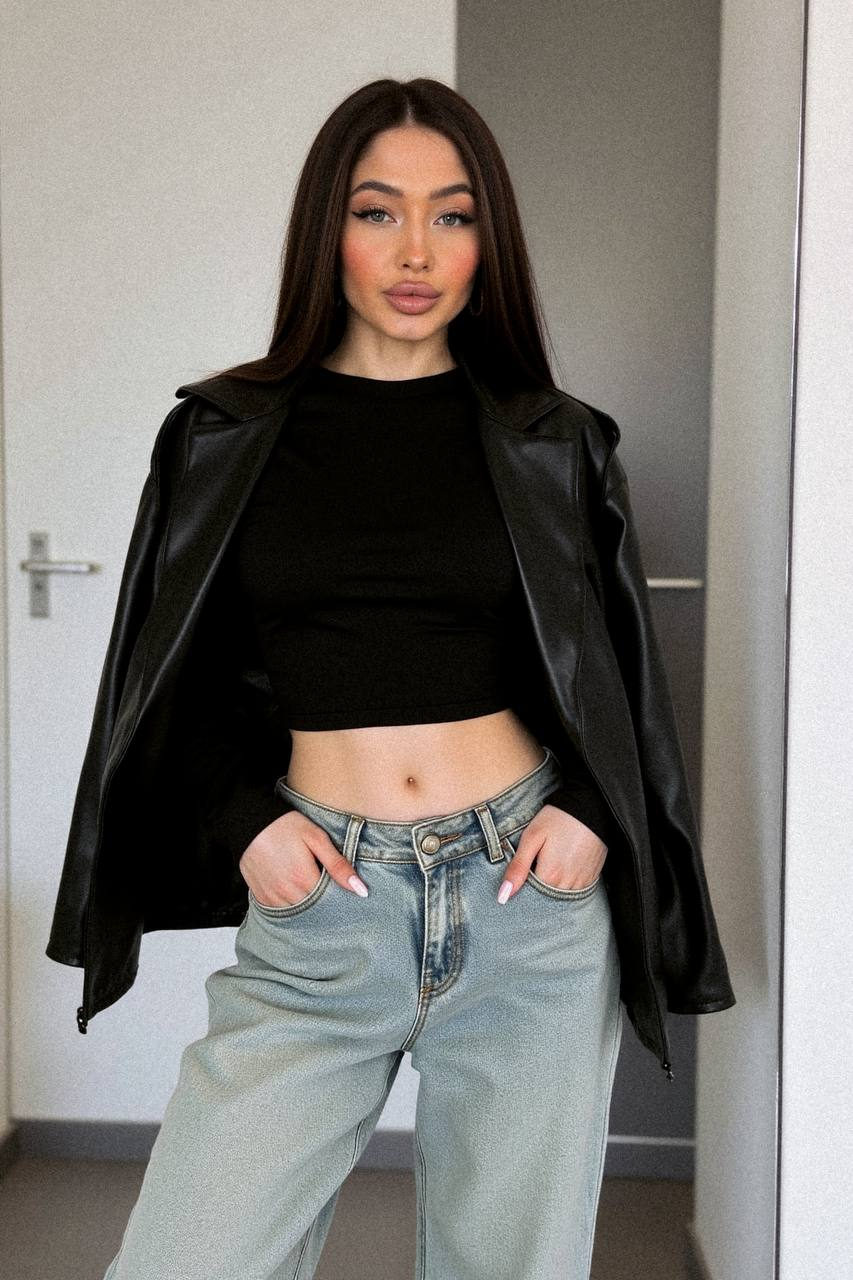Ultra-detailed fashion editorial mirror selfie in modern streetwear. Model with crop top, oversized jeans, and leather jacket in soft natural light.