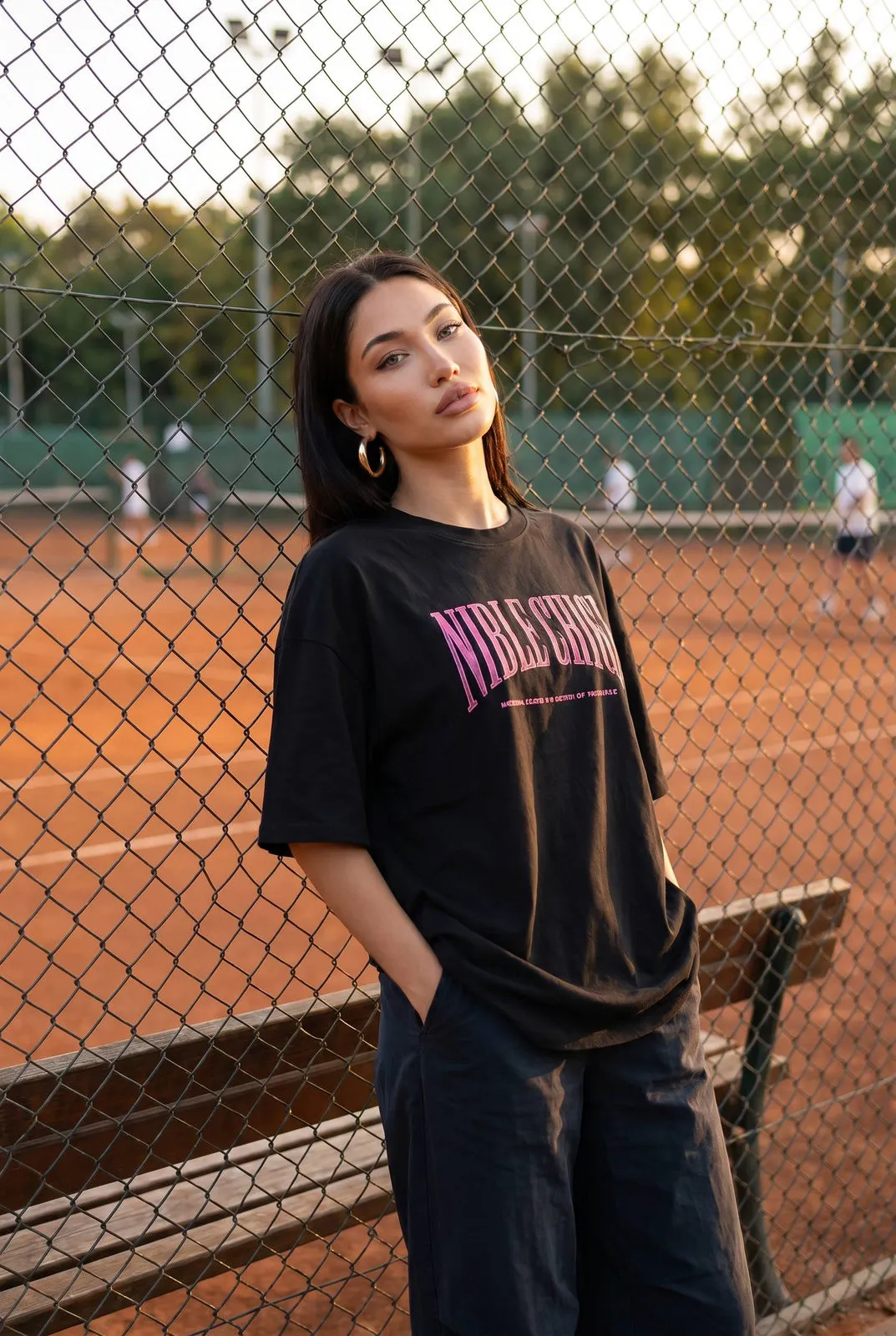 Golden Hour Street Style Woman Tennis Court Fence