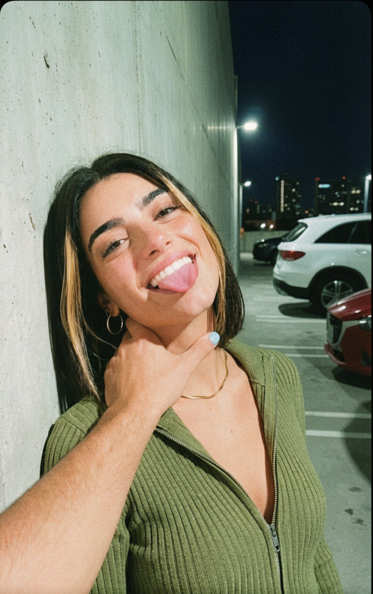 Playful Nighttime Selfie Parking Garage Woman Tongue Out