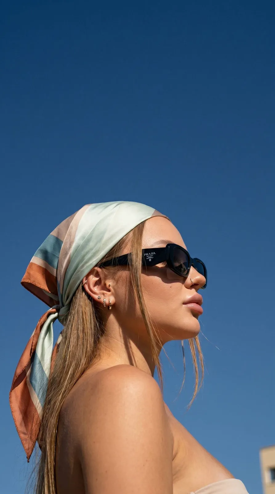 Sunglasses And Earrings In A Low Angle Summer Portrait