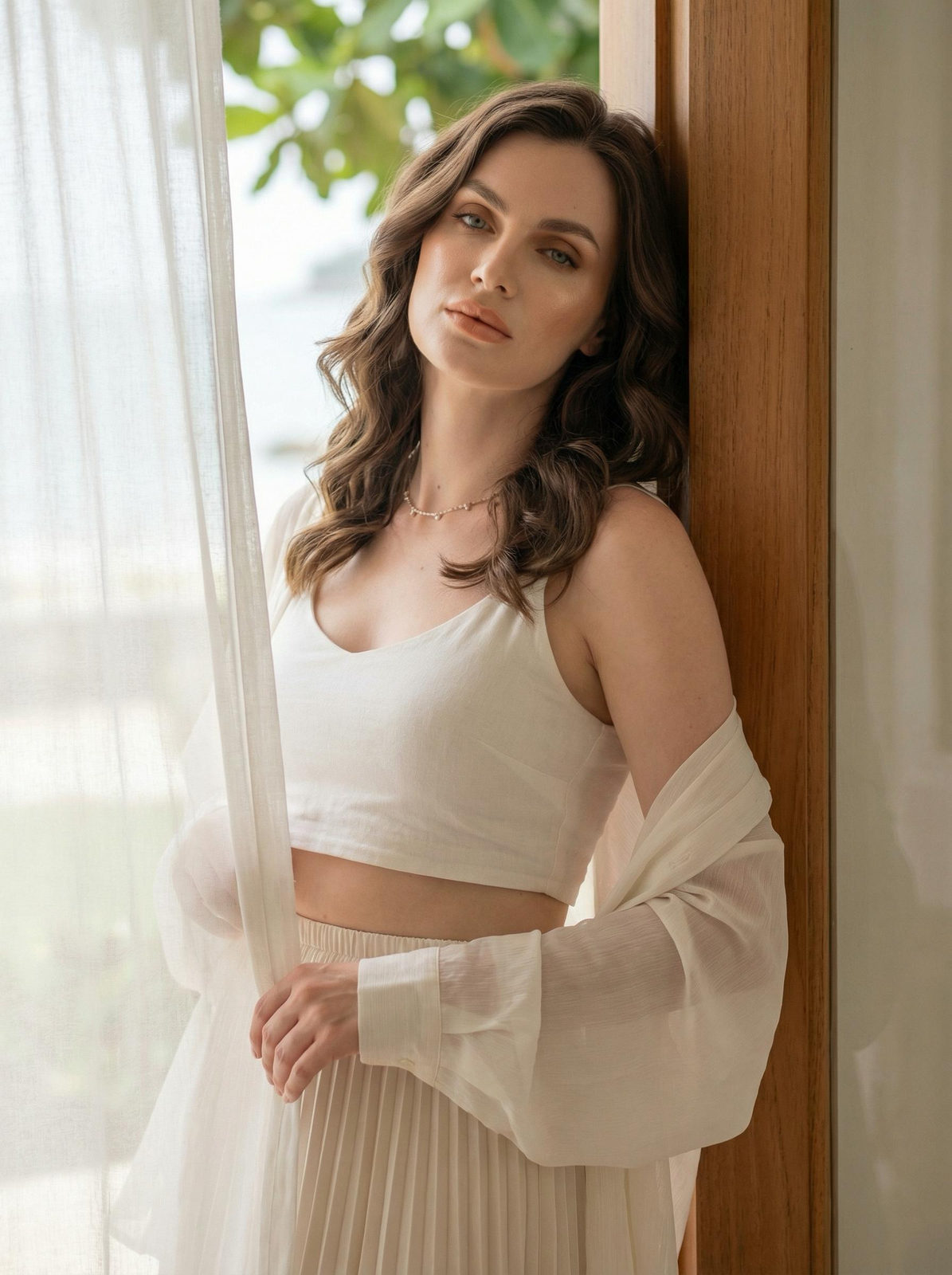 A realistic woman in a doorway with soft natural light, her right arm resting on the frame, showcasing soft, warm makeup.