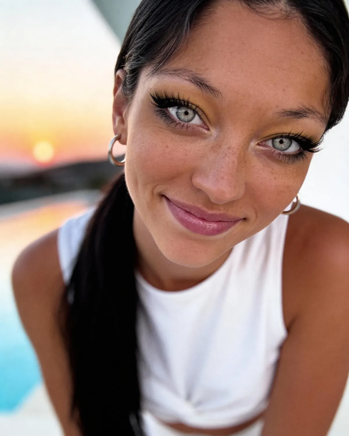 Makeup And Earrings With White Sleeveless Top