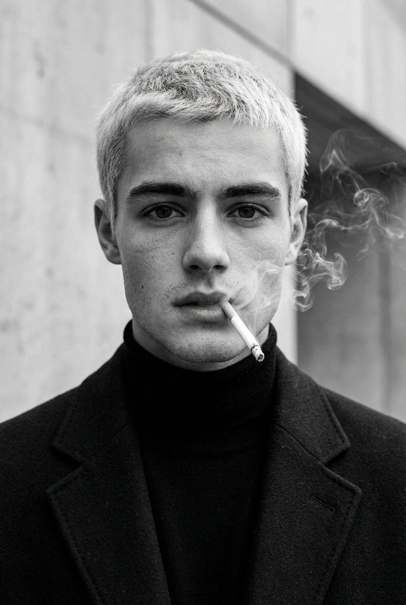 A striking monochrome portrait of a man holding a cigarette with soft smoke curls around his face, showcasing lifelike skin texture and dramatic lighting.