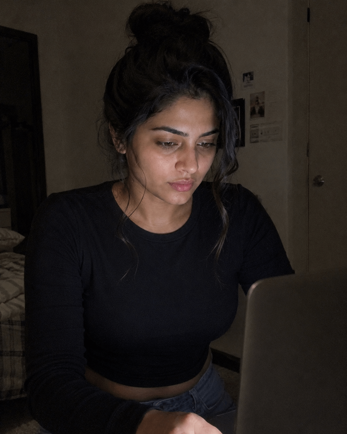 Face Lit By Laptop Screen In Dark Bedroom