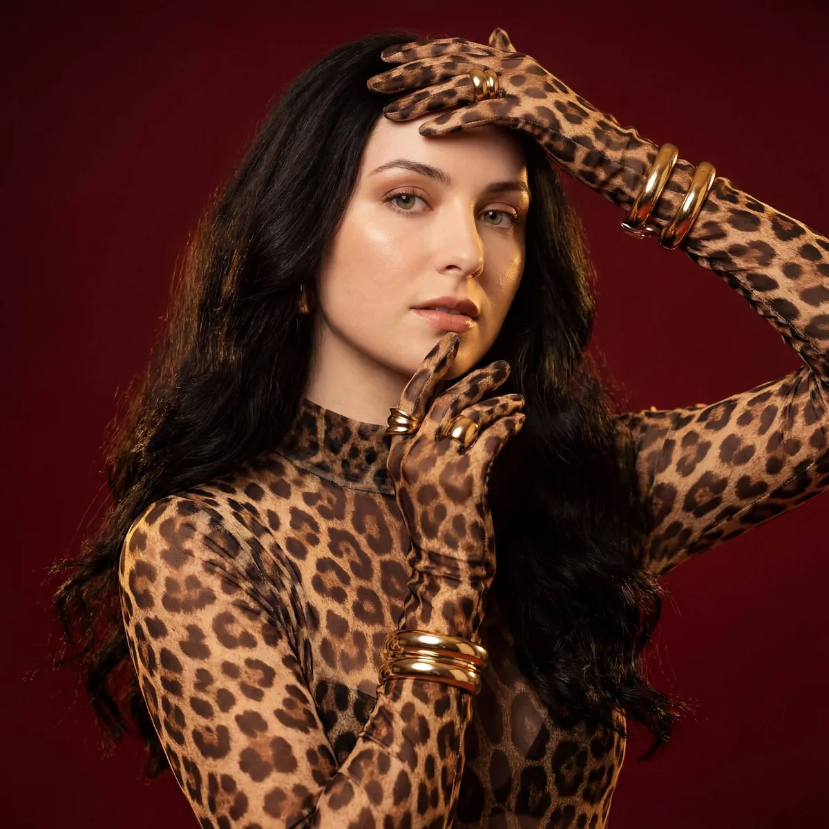 Woman Leopard Bodysuit Gold Jewelry Red Backdrop