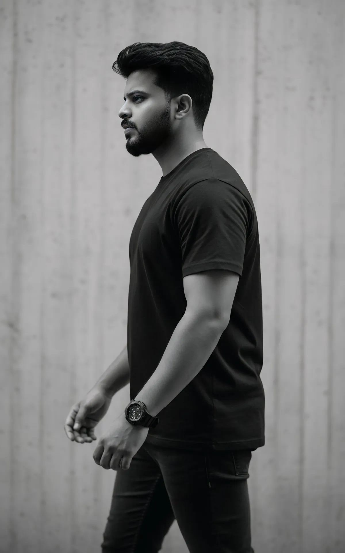 Black and white portrait of a young man walking in profile view