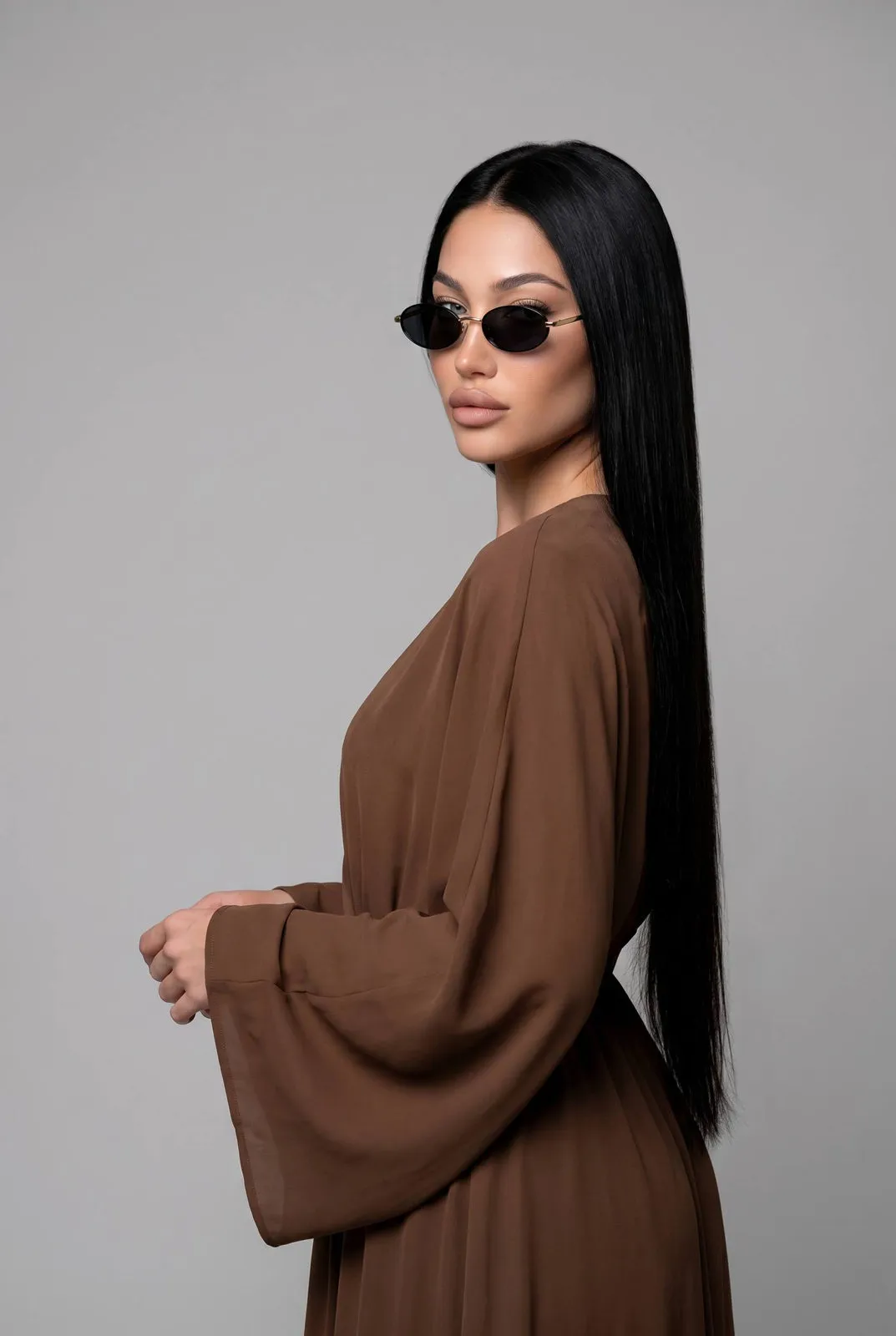 Sunglasses And Makeup With Brown Dress In Gray Studio